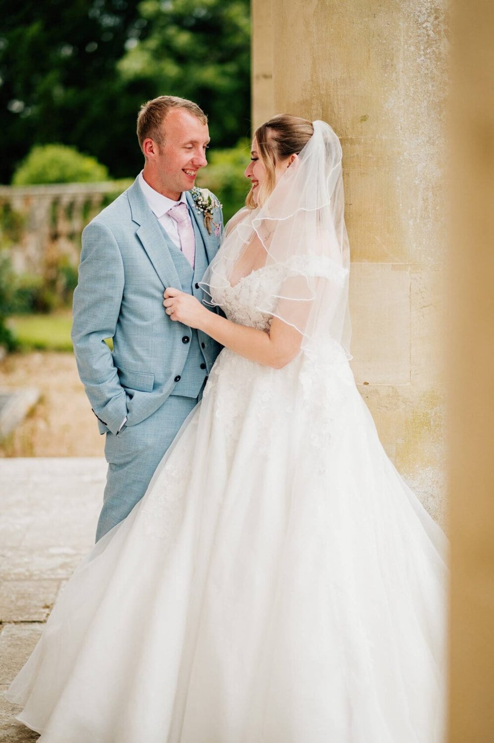 bridal portraits by the columns at Hale Park House Wedding