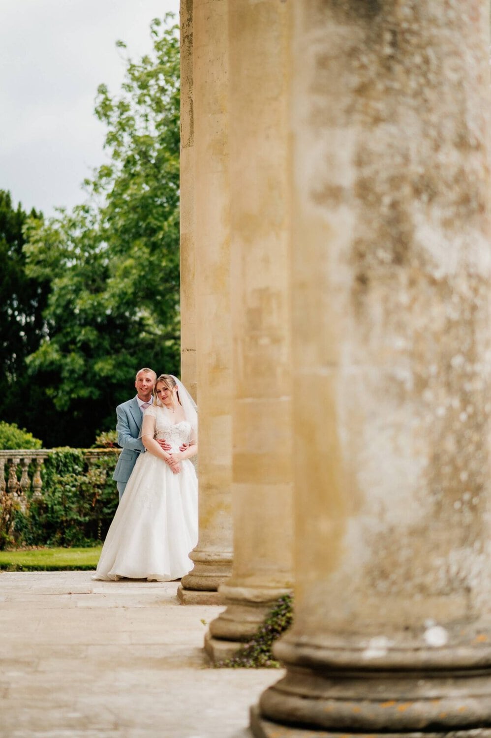 front of the house with bride and groom at Hale Park house