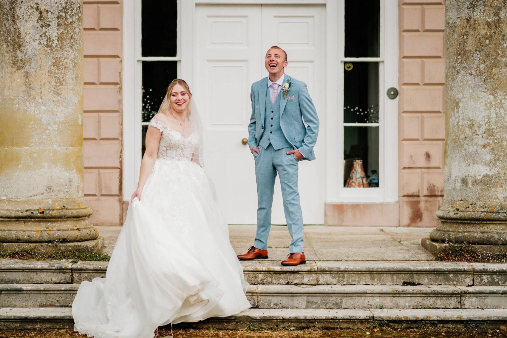 bride and groom stands out the front of hale park house