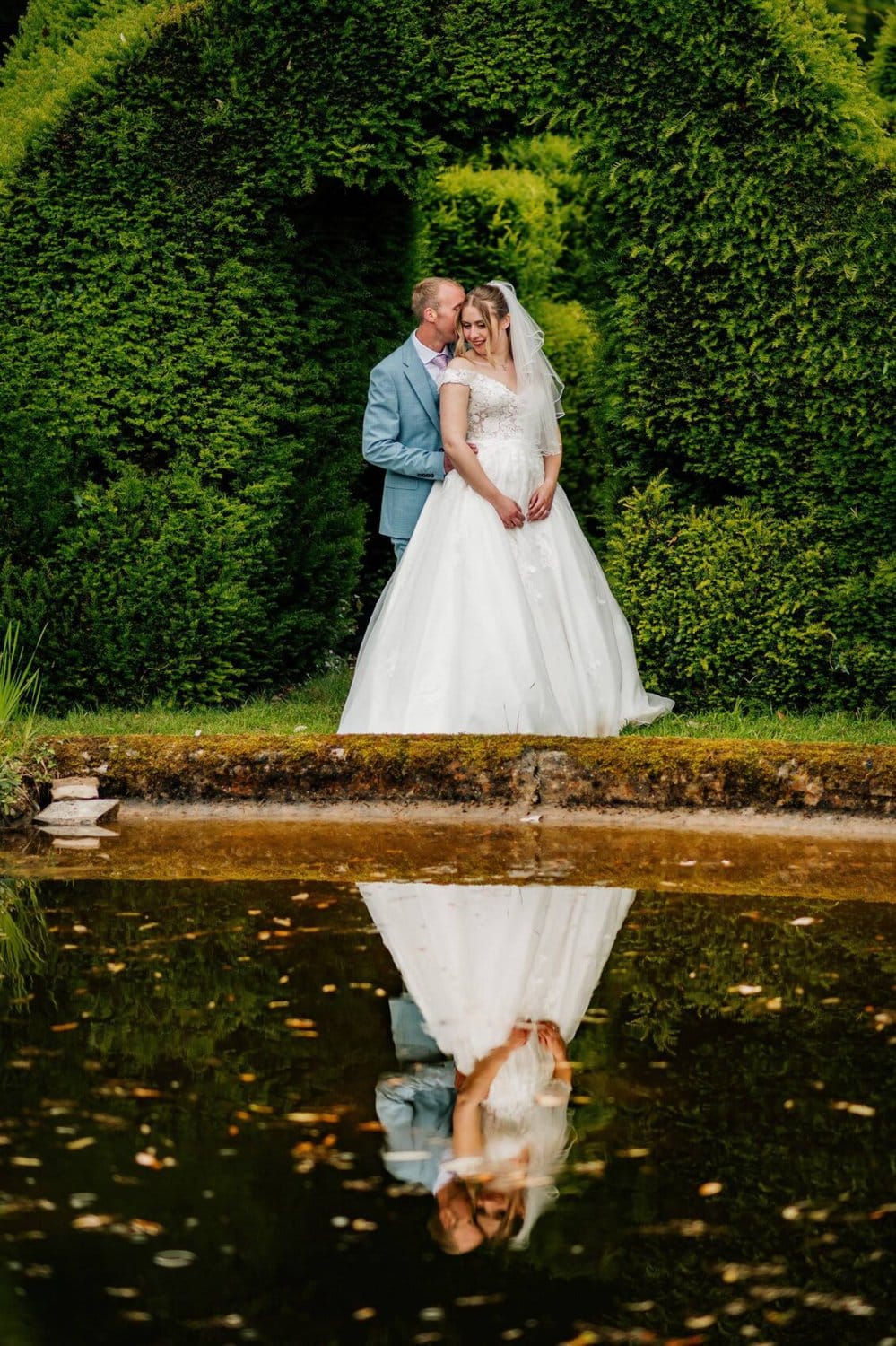 bride and groom and their reflection at Hale Park House Wedding