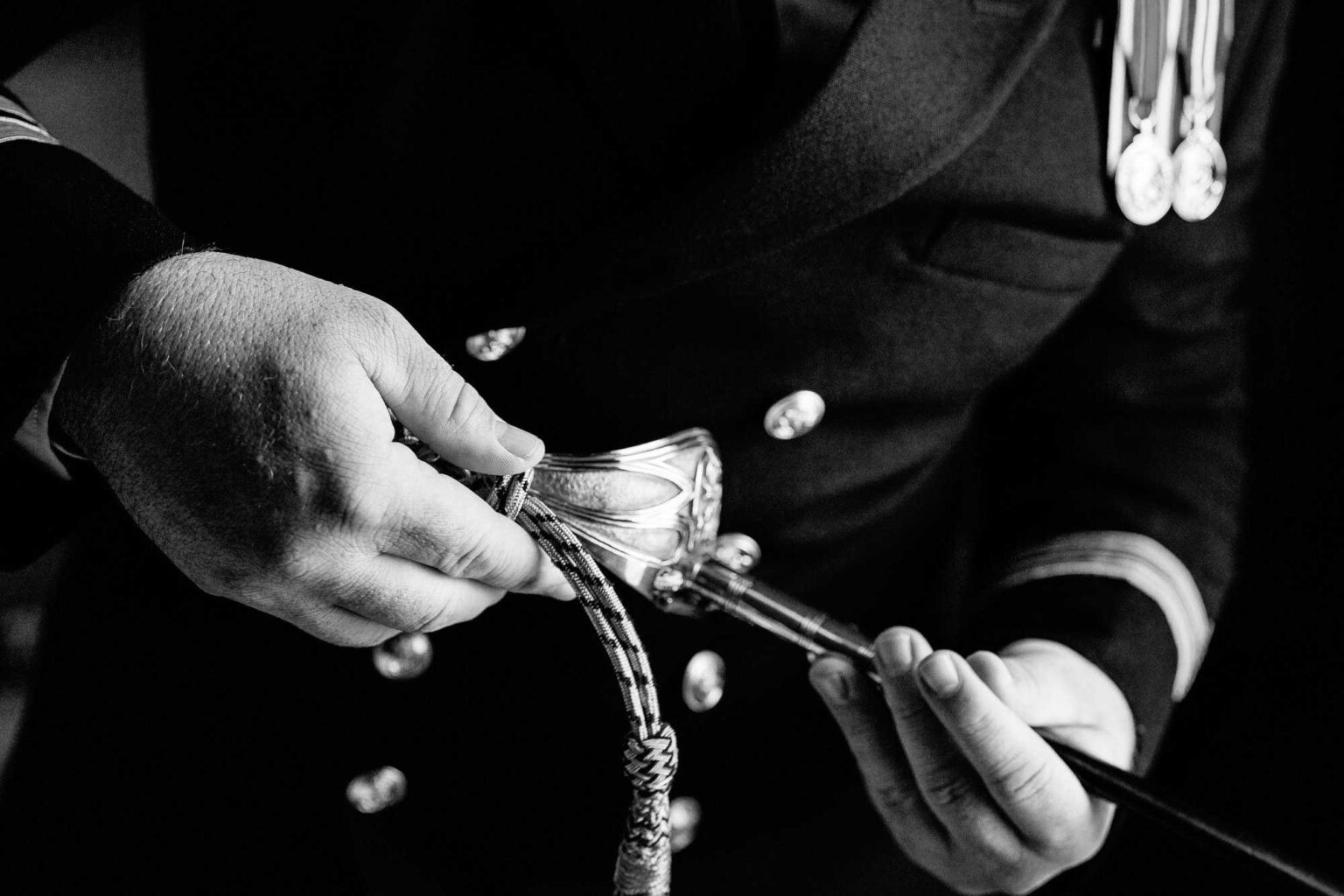 Groom inspects his sword before his River Cottage wedding