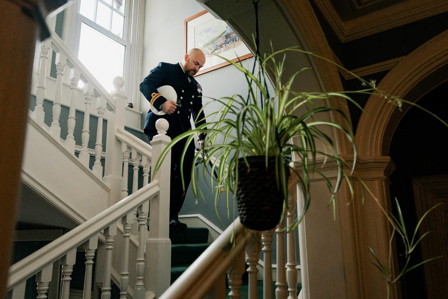 River Cottage wedding Groom decends the stairs at nearby hotel