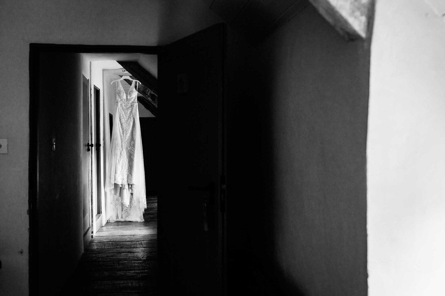 Brides dress hangs from a beam in River Cottage