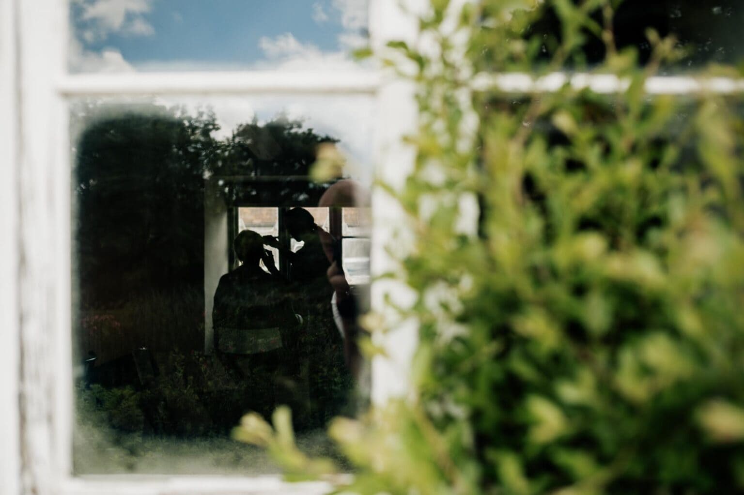 Make up preparation viewed through the window at River Cottage wedding