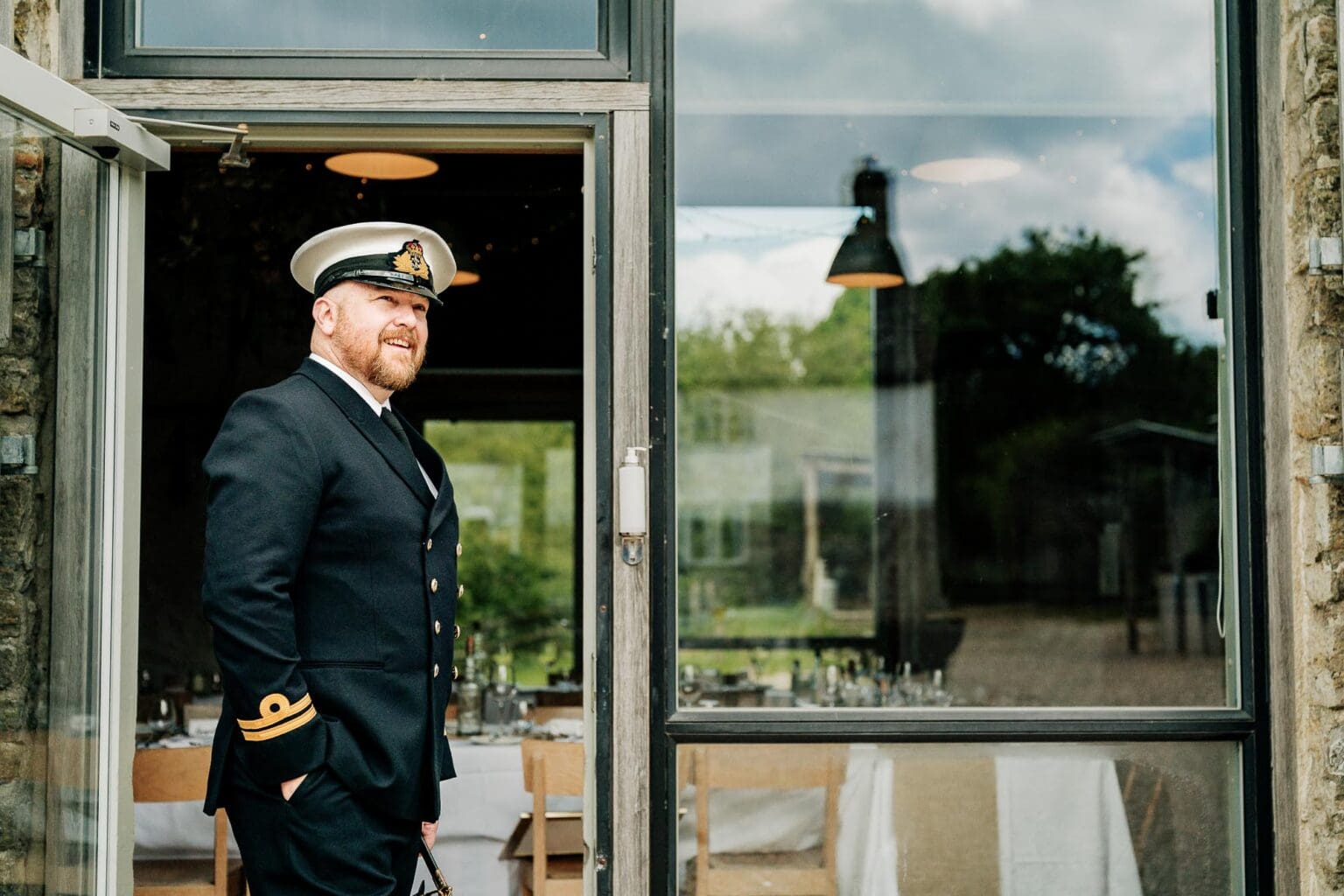 Groom waiting for guests at his River Cottage wedding