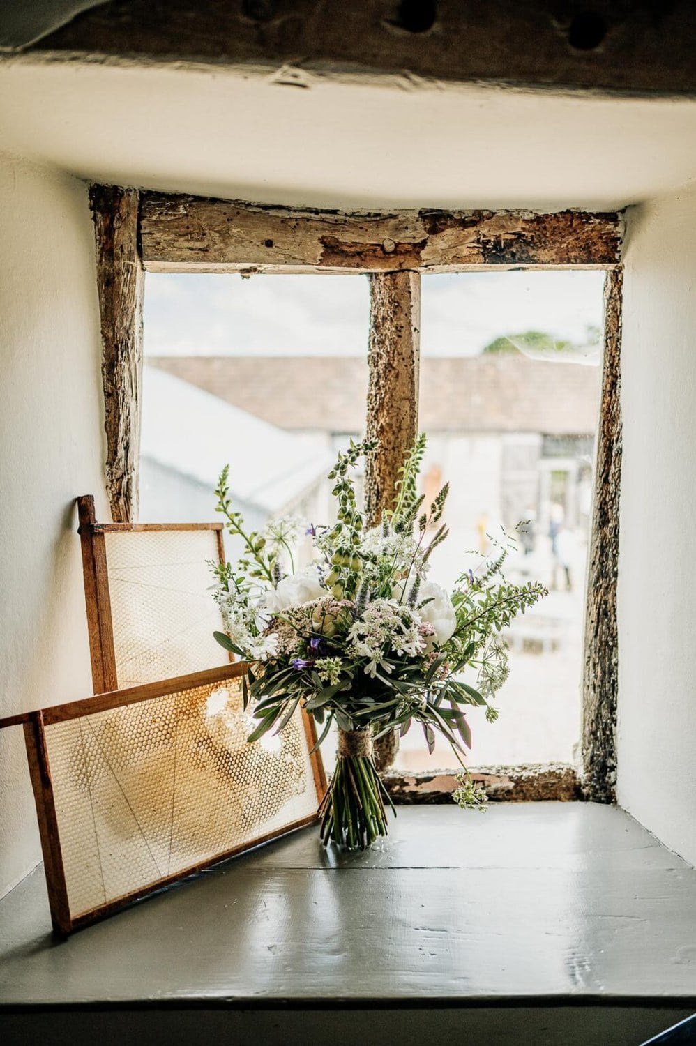 Flowers and honeycombs in the window of River Cottage