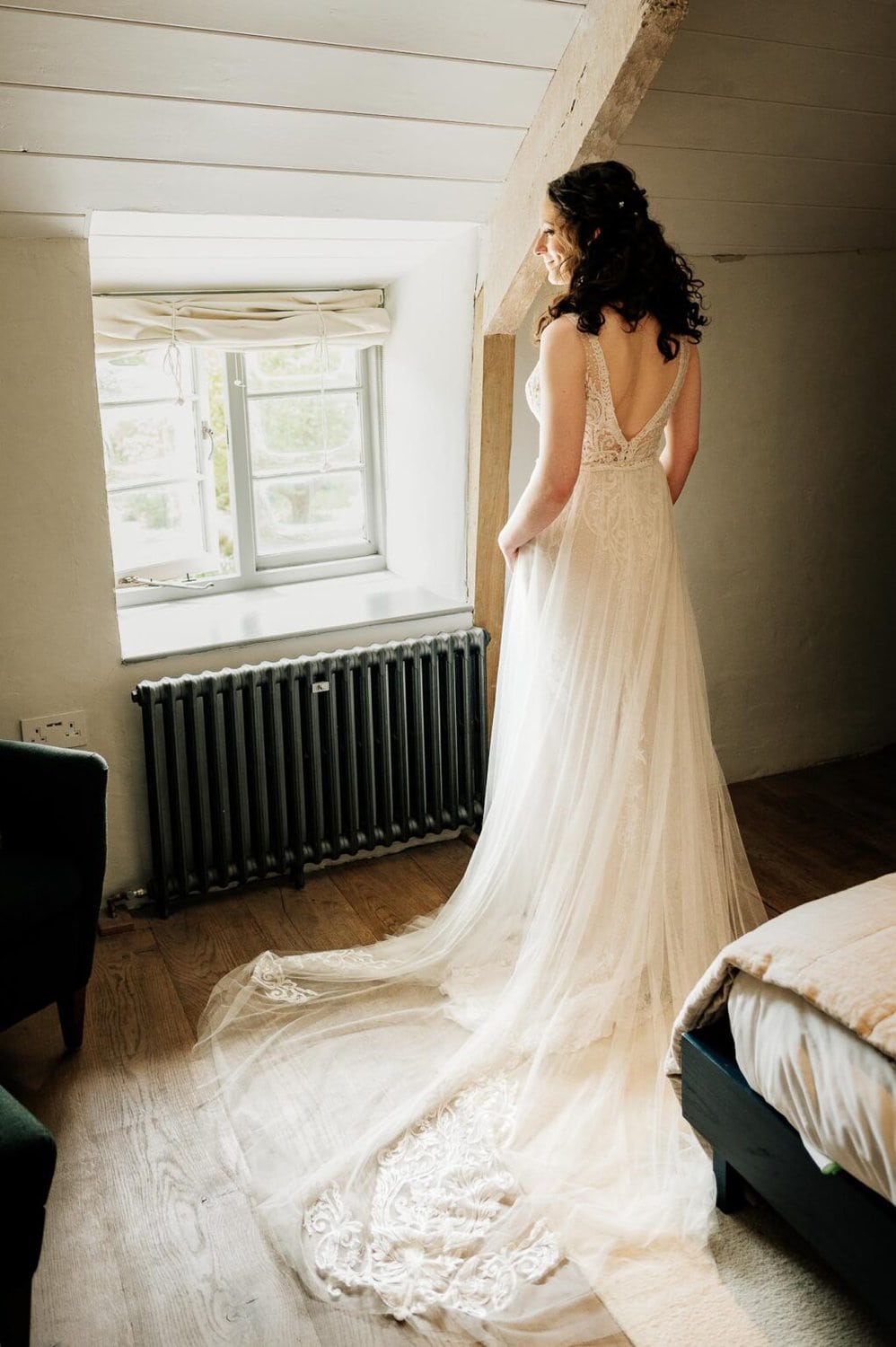 Bride looks out of the window of River Cottage wedding