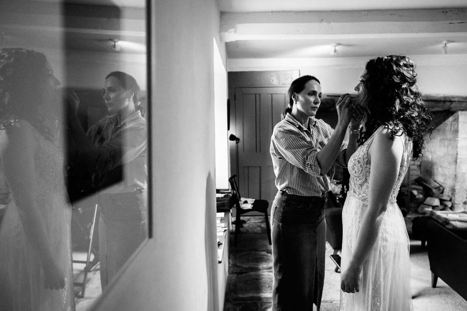 Final touches to the brides make up before her summer garden wedding at River Cottage HQ