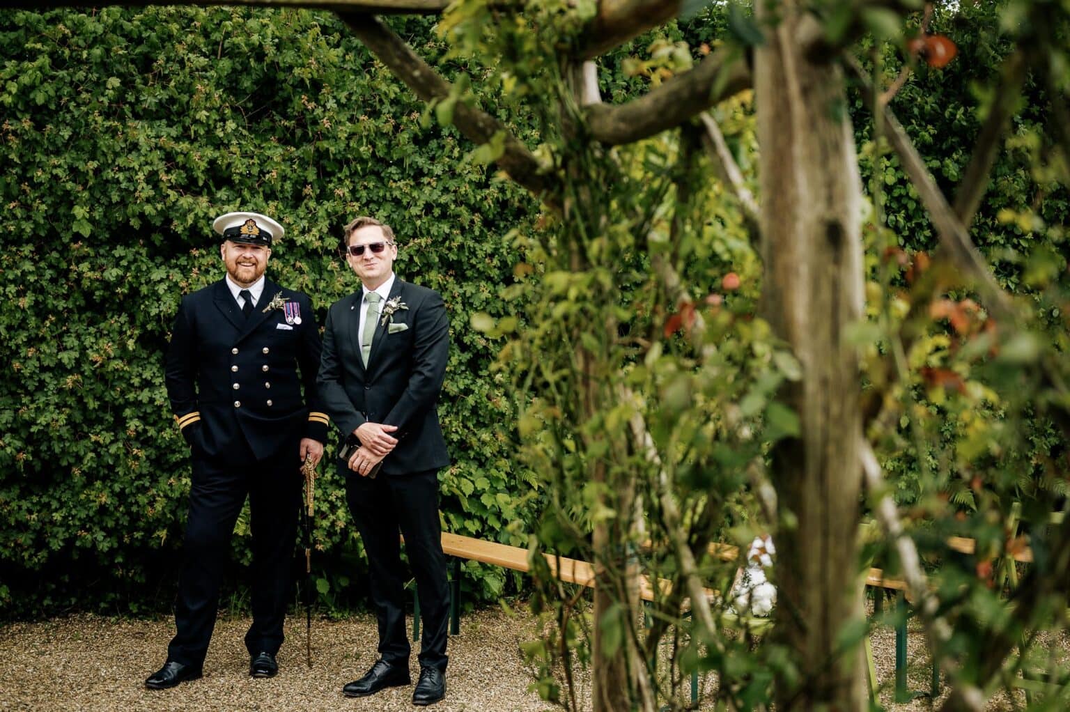 Groom waits for the wedding party to walk out from the cottage at River Cottage wedding