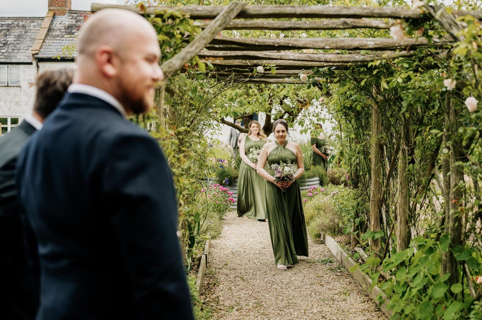 Groom watches the bridesmaids arrive