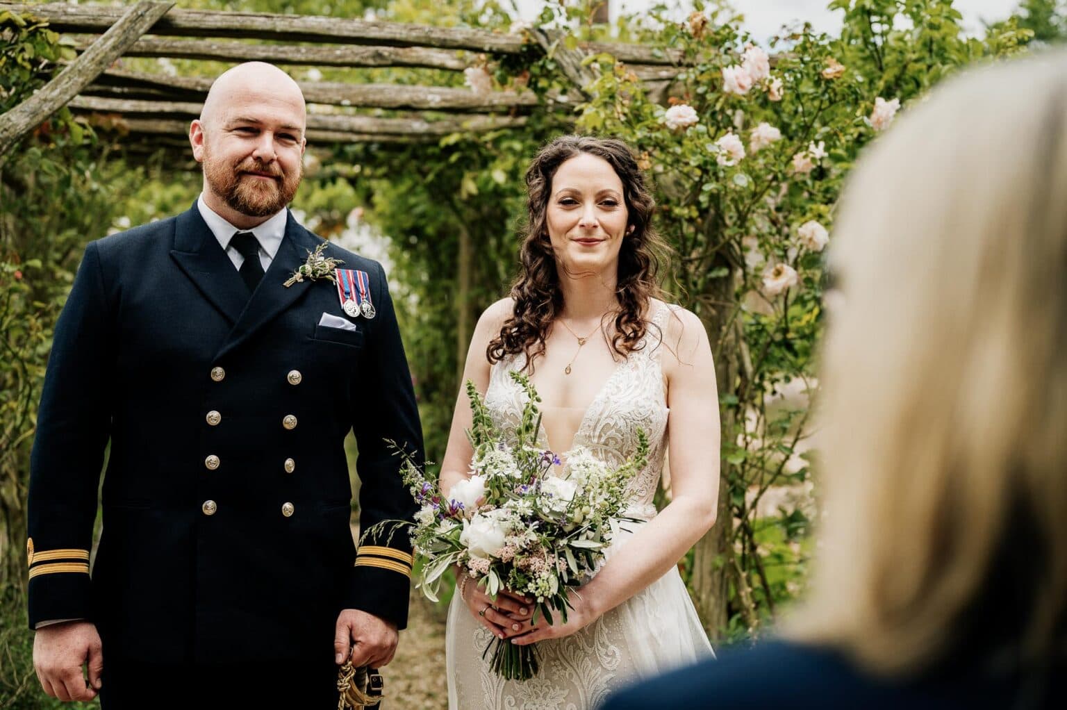 Bride and groom listening to vows at River Cottage wedding