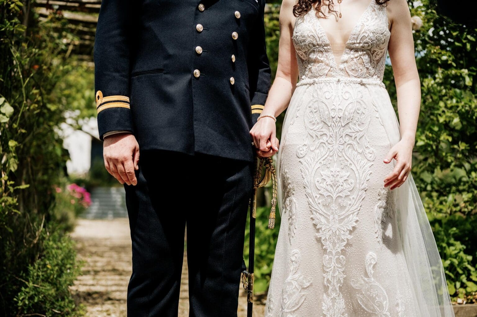 bride and groom hold hands at River Cottage garden wedding