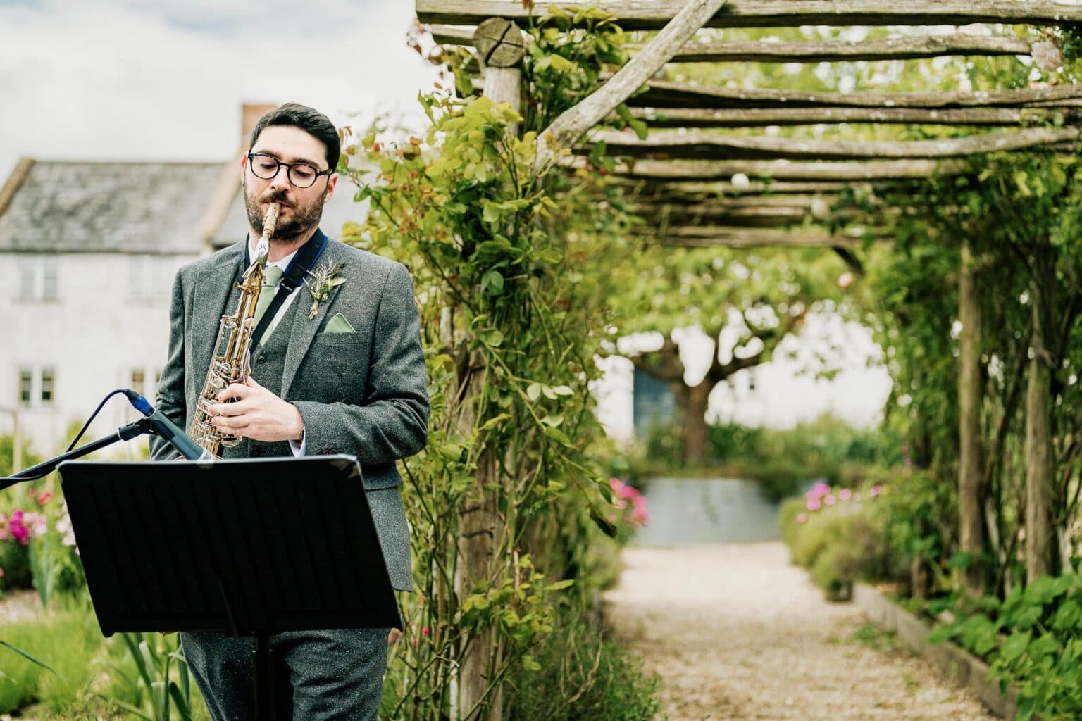 brother plays saxaphone at River Cottage garden wedding