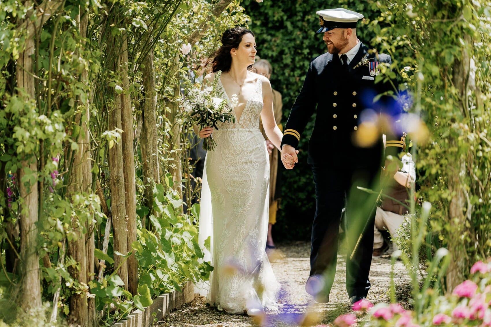 Bride and Groom walk together after their ceremony at River Cottage wedding