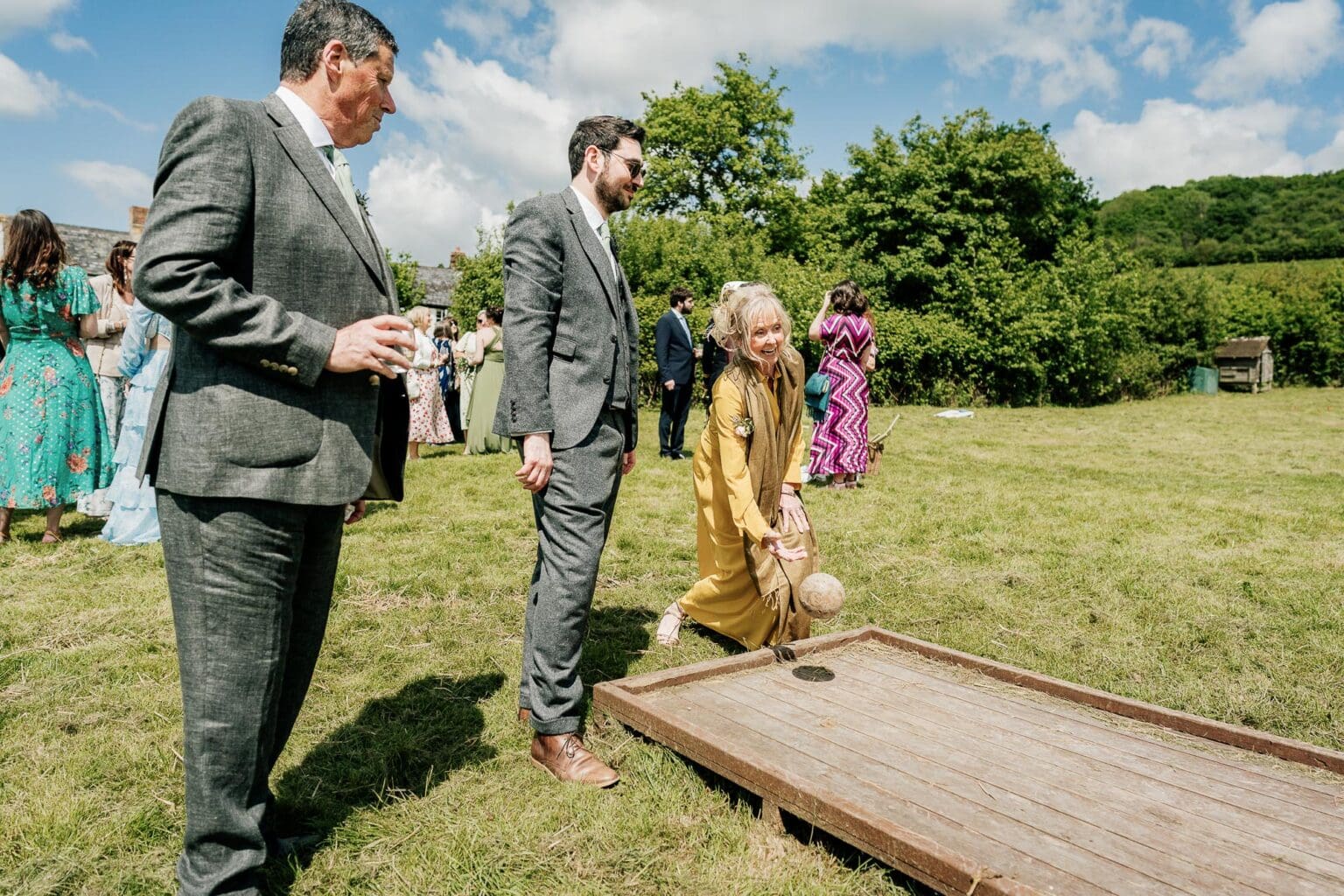 mother of the bride plays skittles in the garden