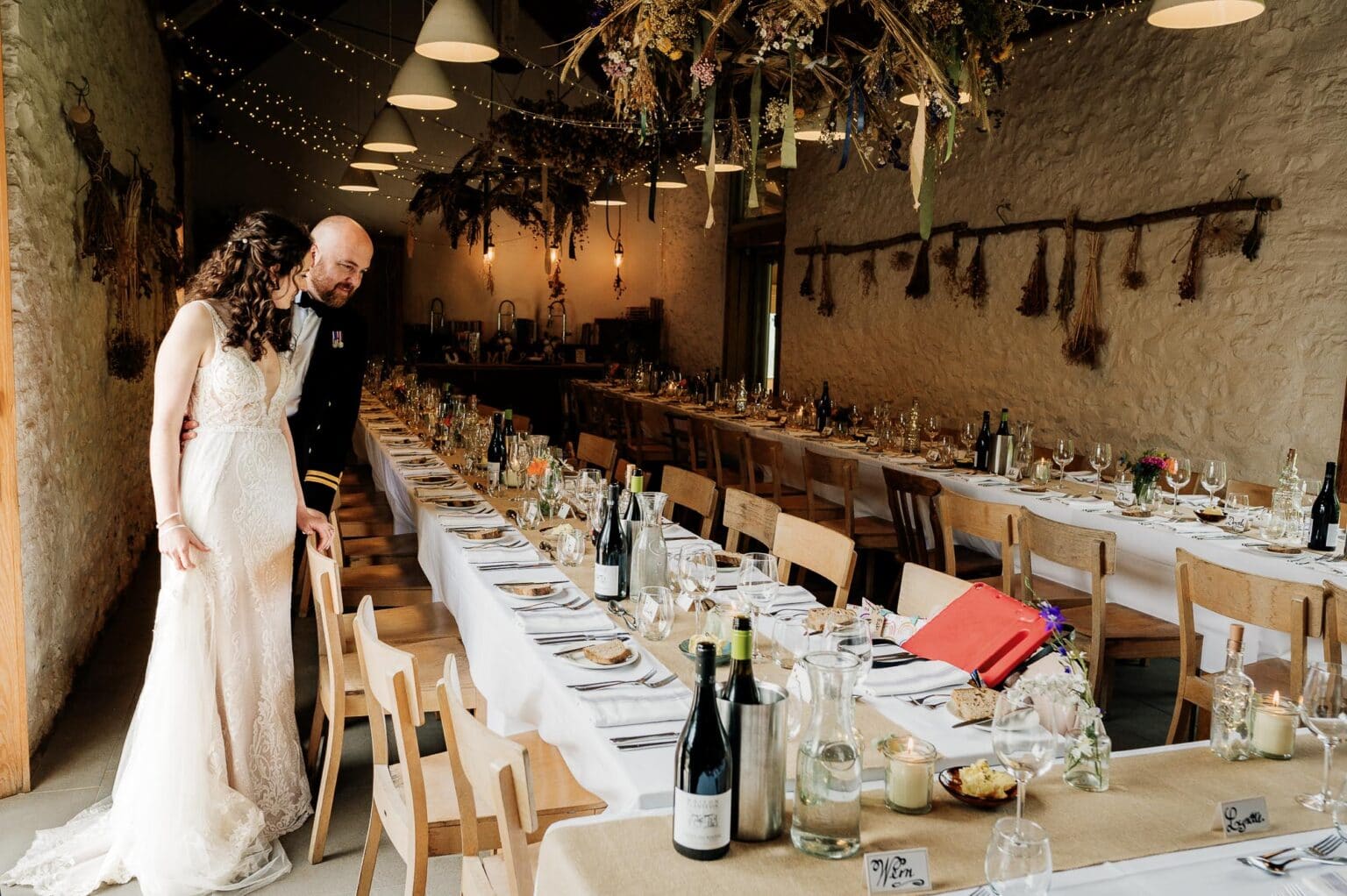 Bride and groom inspect the barn at River cottage reception