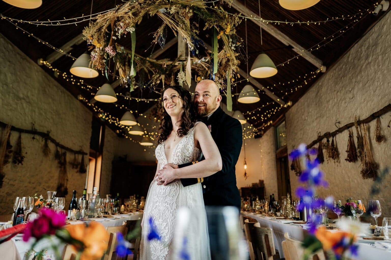 Bride and Groom in window light in the BArn Reception at River Cottage garden wedding