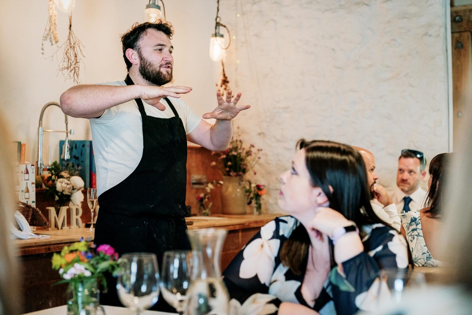 The chef talks about the food he is about to serve to the guests at River cottage HQ wedding