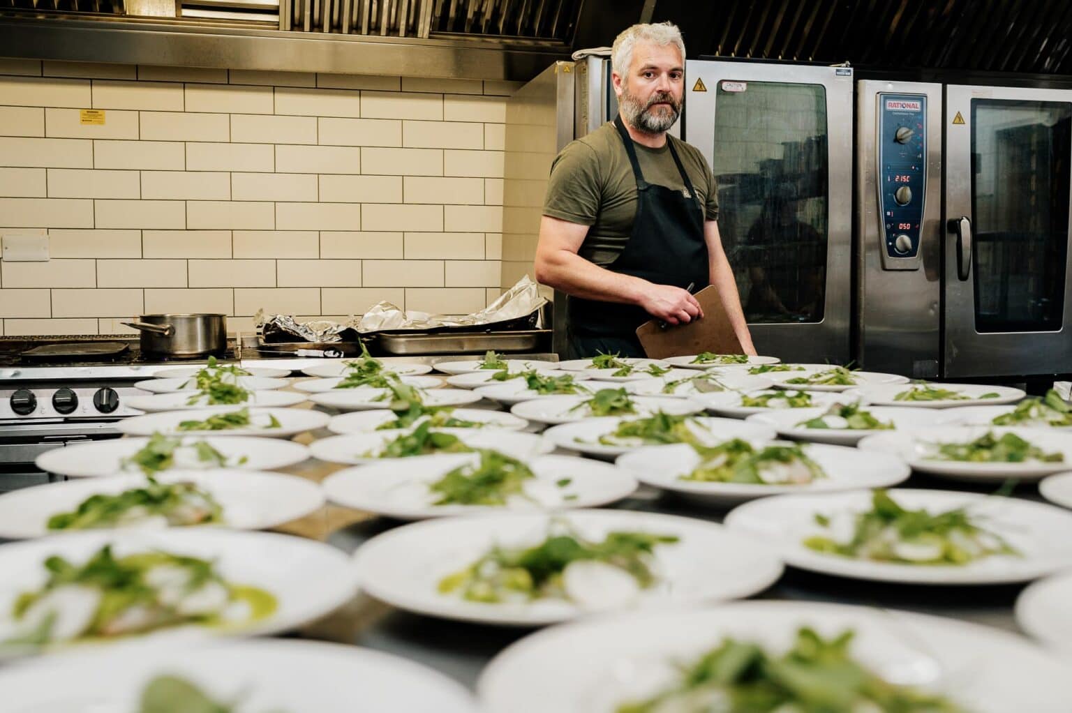 Chef in the kitchen at River cottage HQ wedding