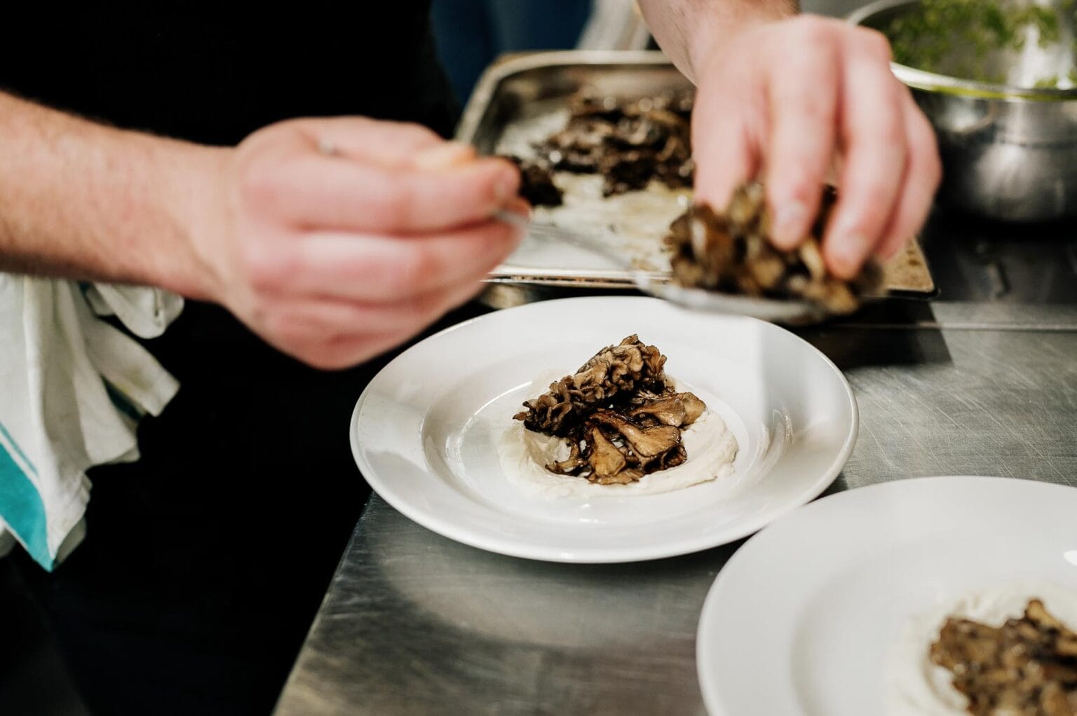 Chef hard at work in the kitchen of River cottage HQ wedding