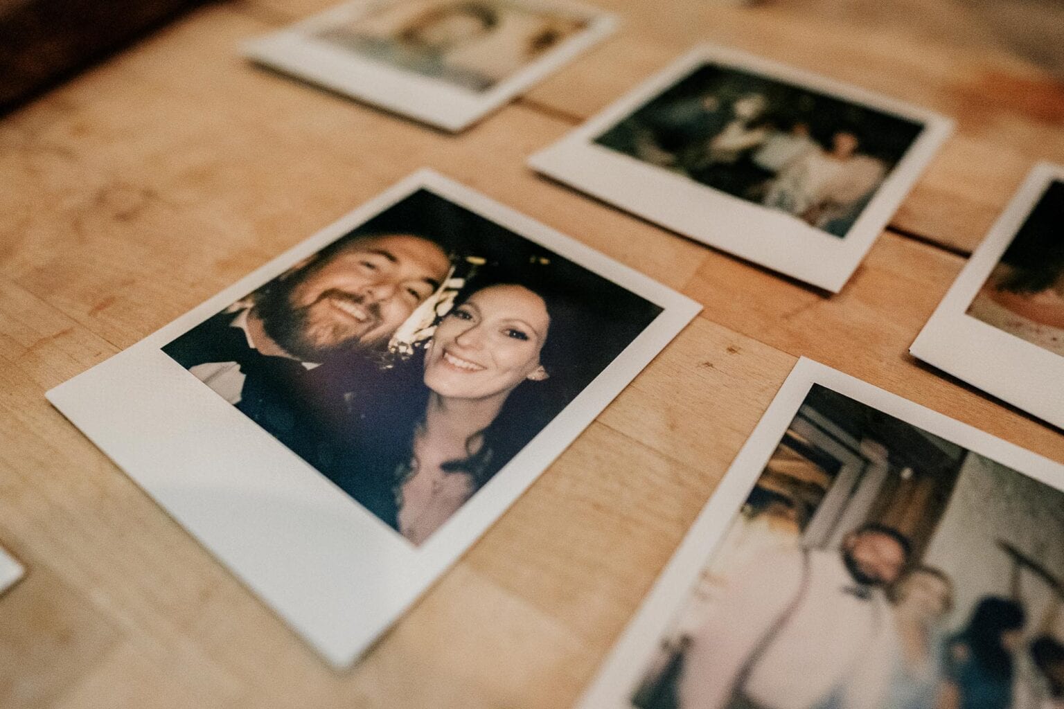 Polaroids on a table at River cottage HQ wedding