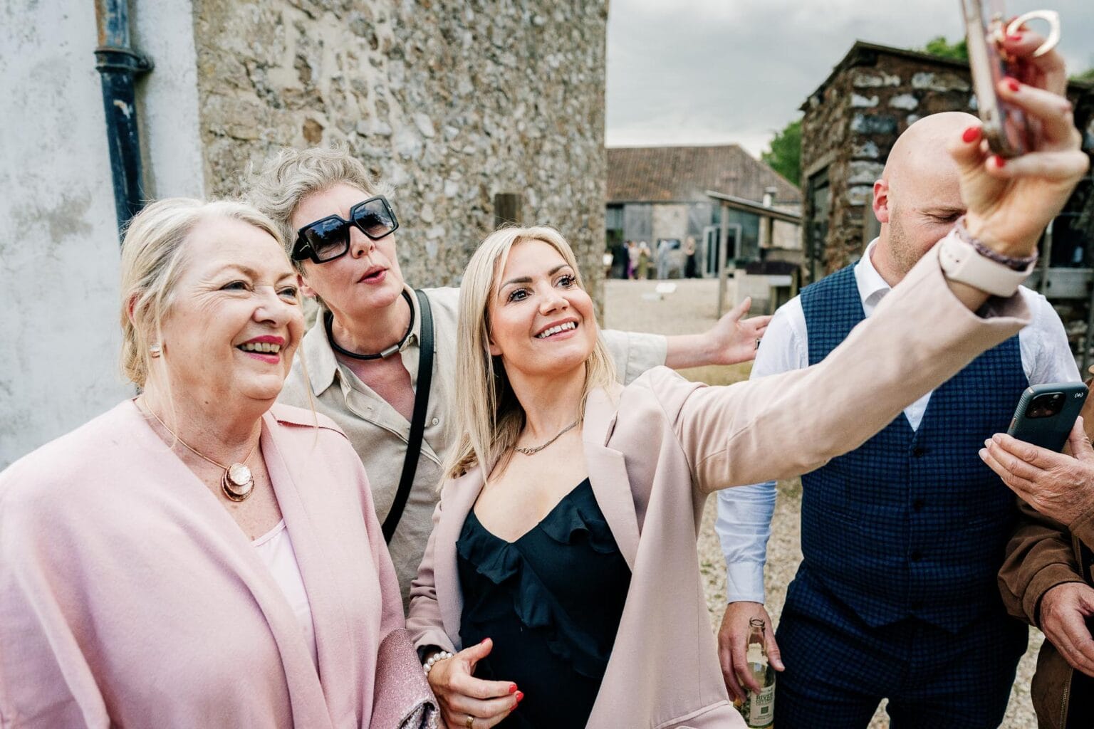 Geusts taking selfies in the garden at River cottage HQ wedding