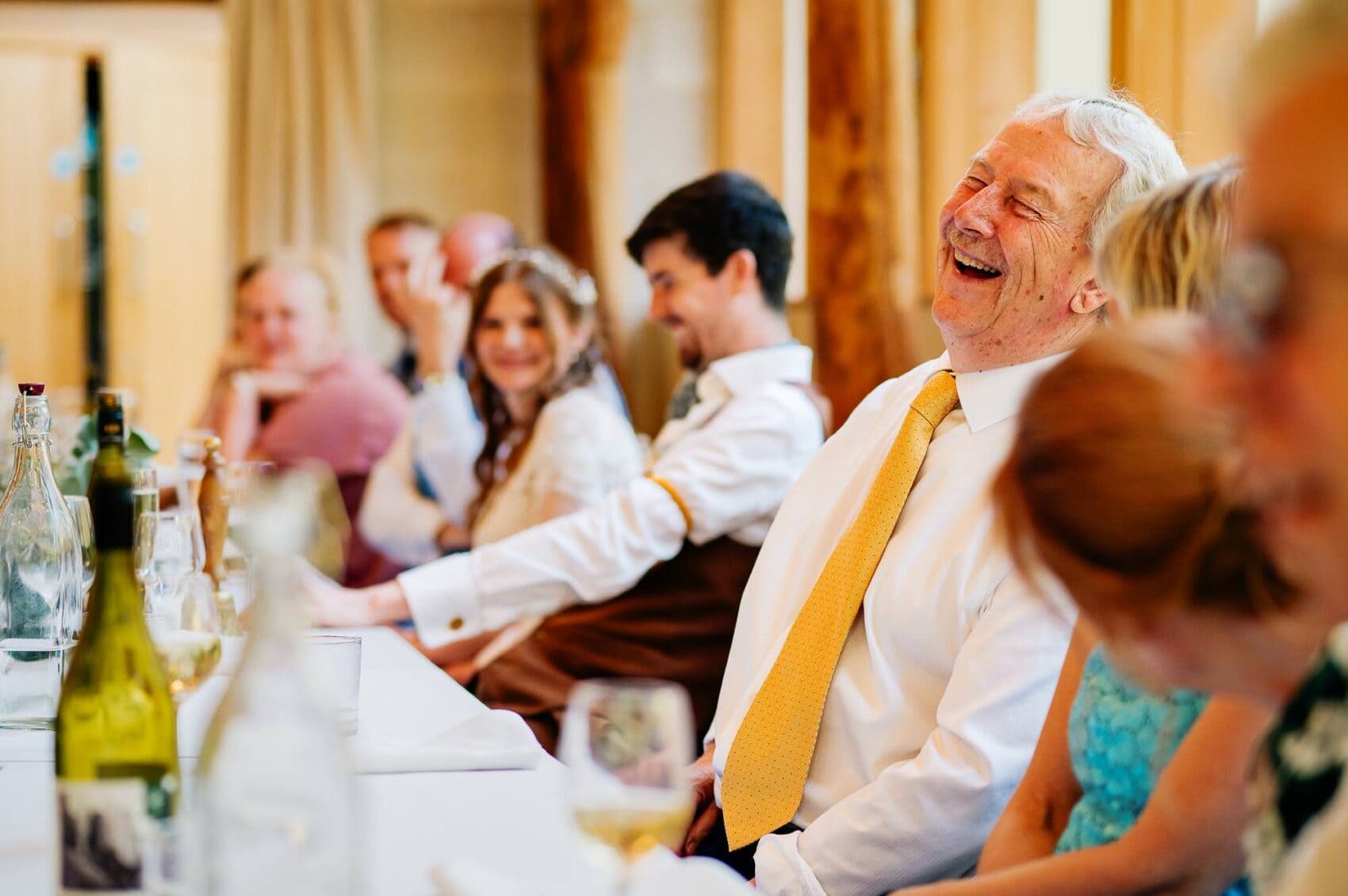 Top table laugh at the Owlpen Manor weddding speeches