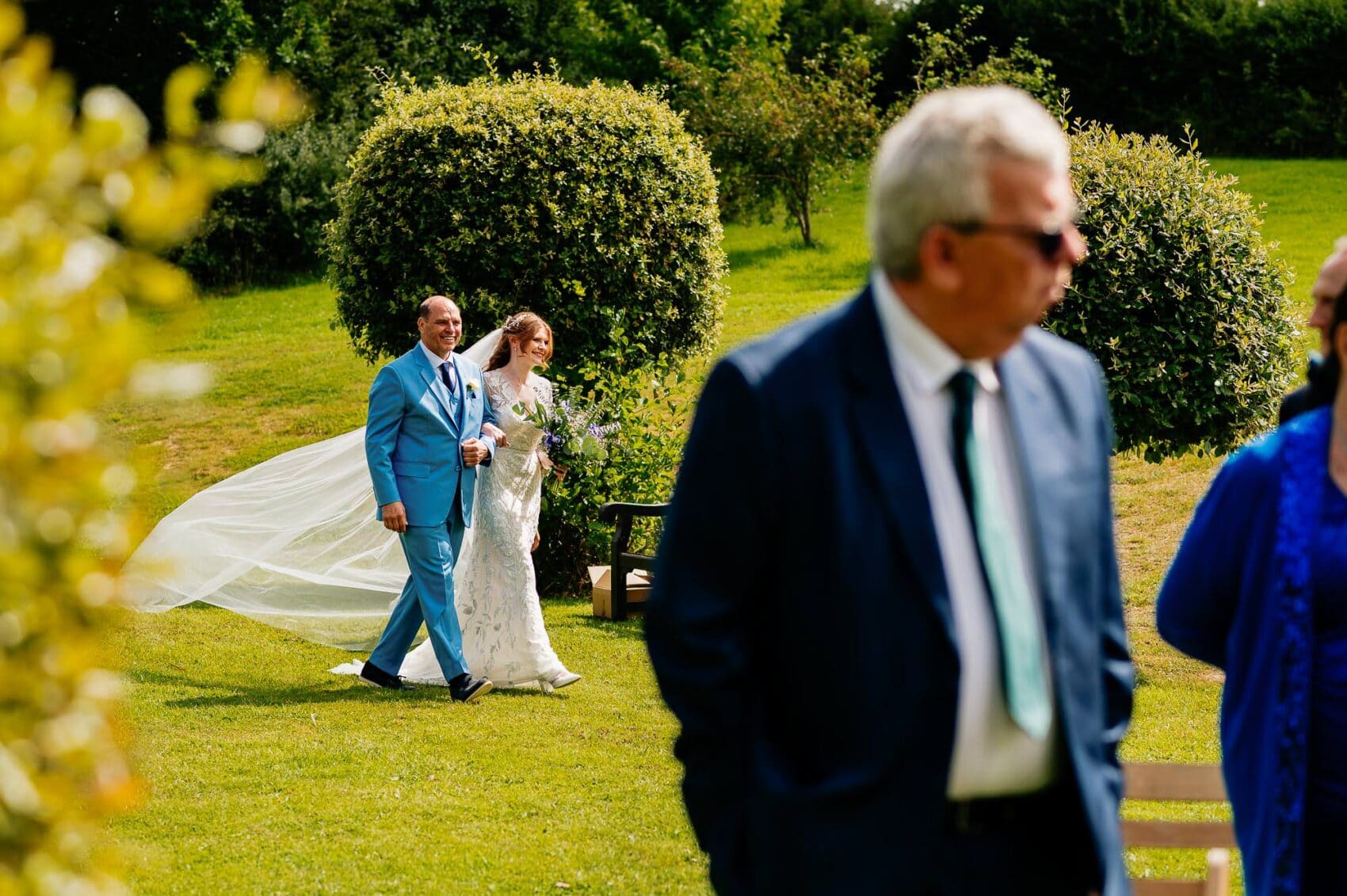 Dad and the bride walk the lawn to the outdoor ceremony at Owlpen Manor weddding