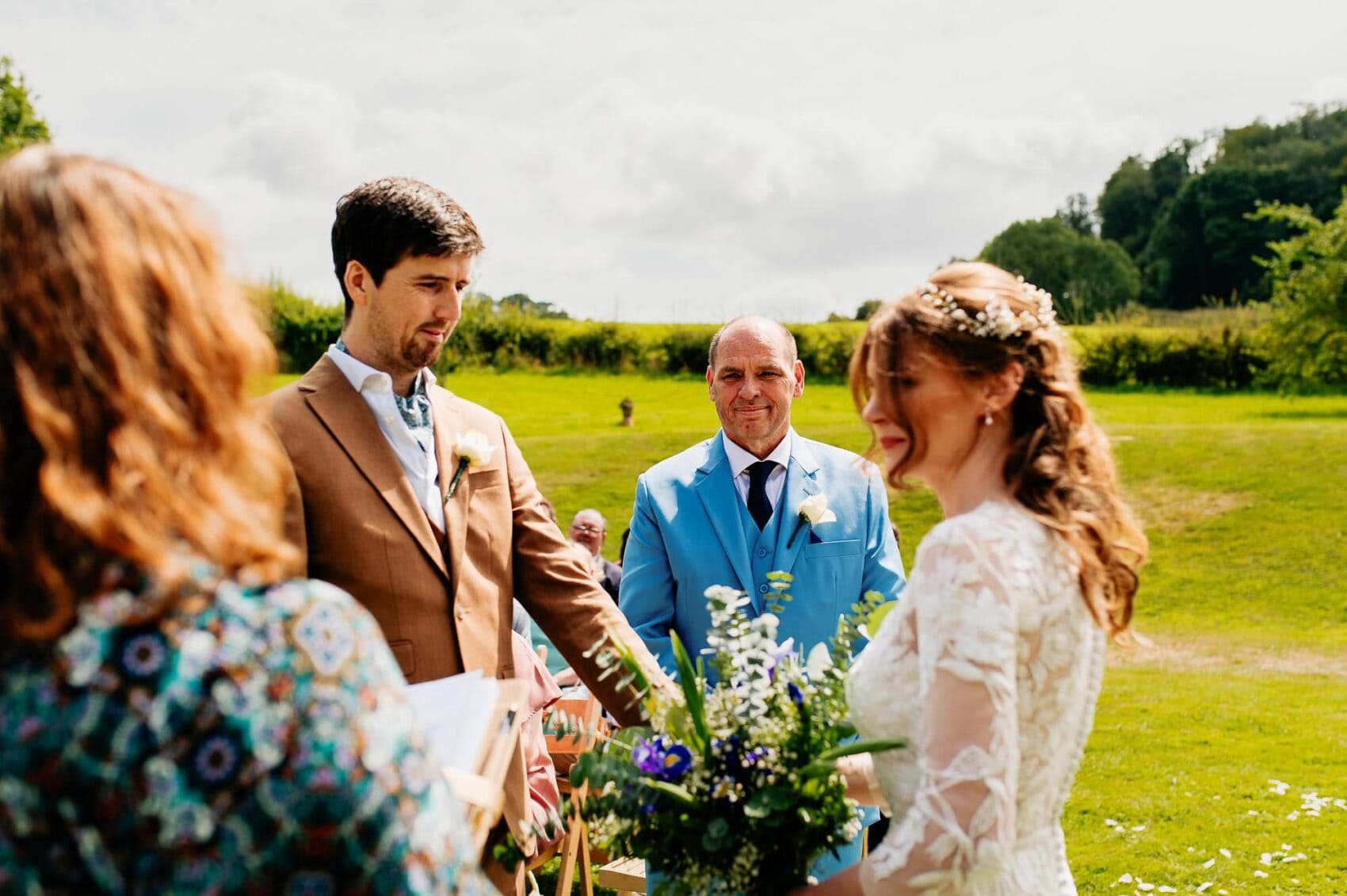 Dad looks on as his daughter begins her vows at Owlpen Manor weddding