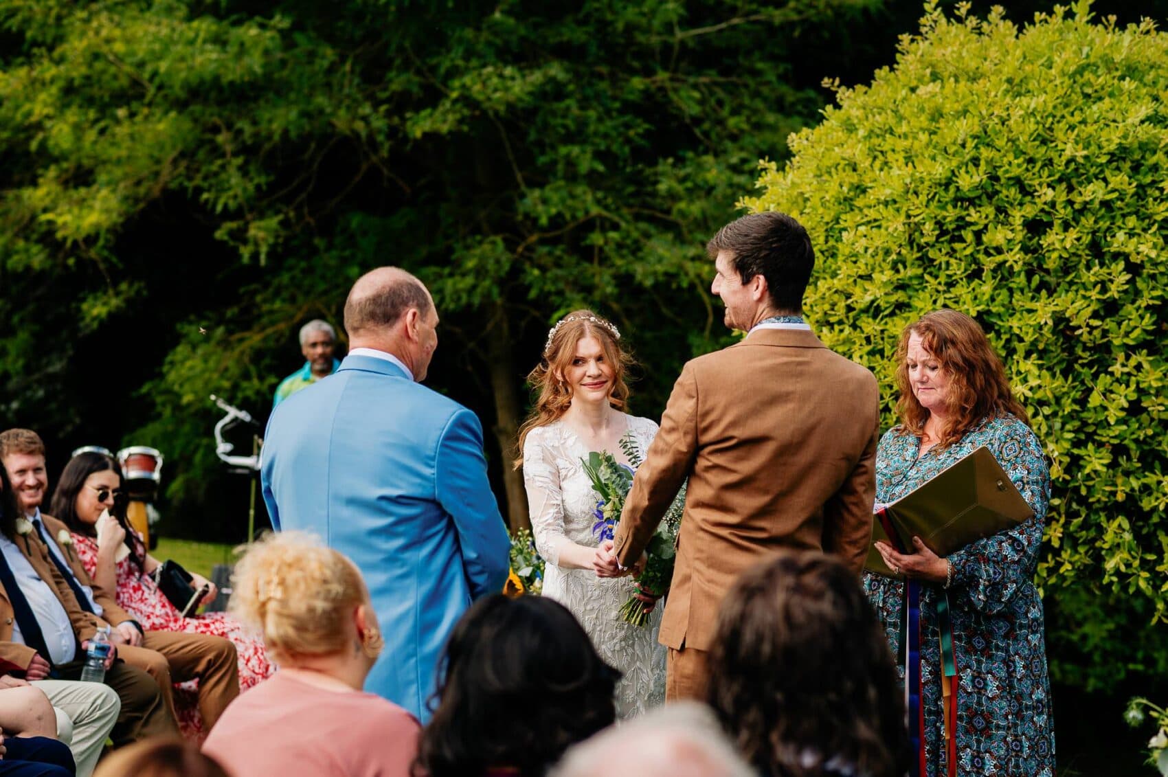 Brides look at her dad during the vows at Owlpen Manor weddding