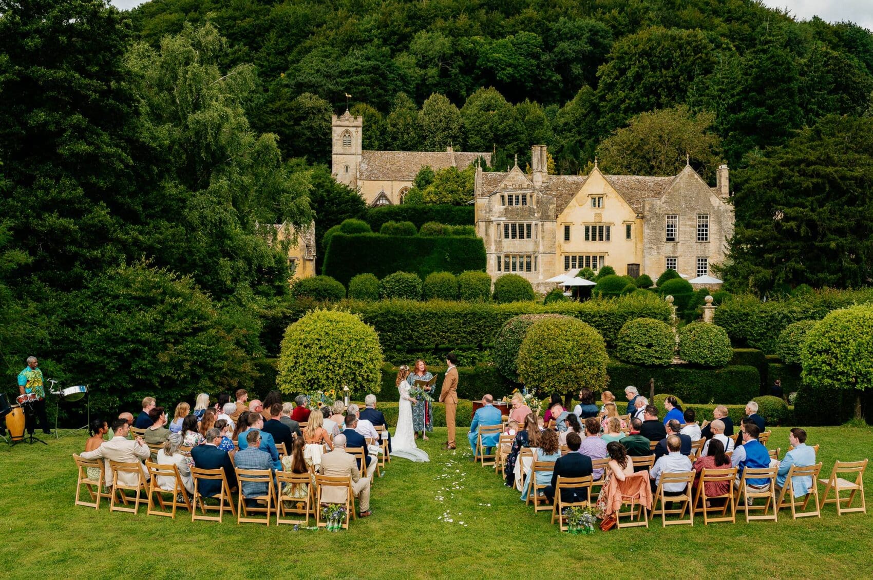 Outdoor ceremony showing the house at Owlpen Manor weddding