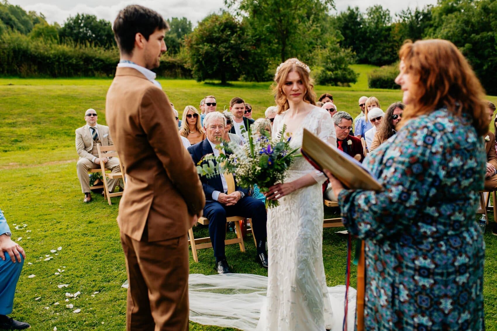 Father of the groom listens intently at the wedding vows