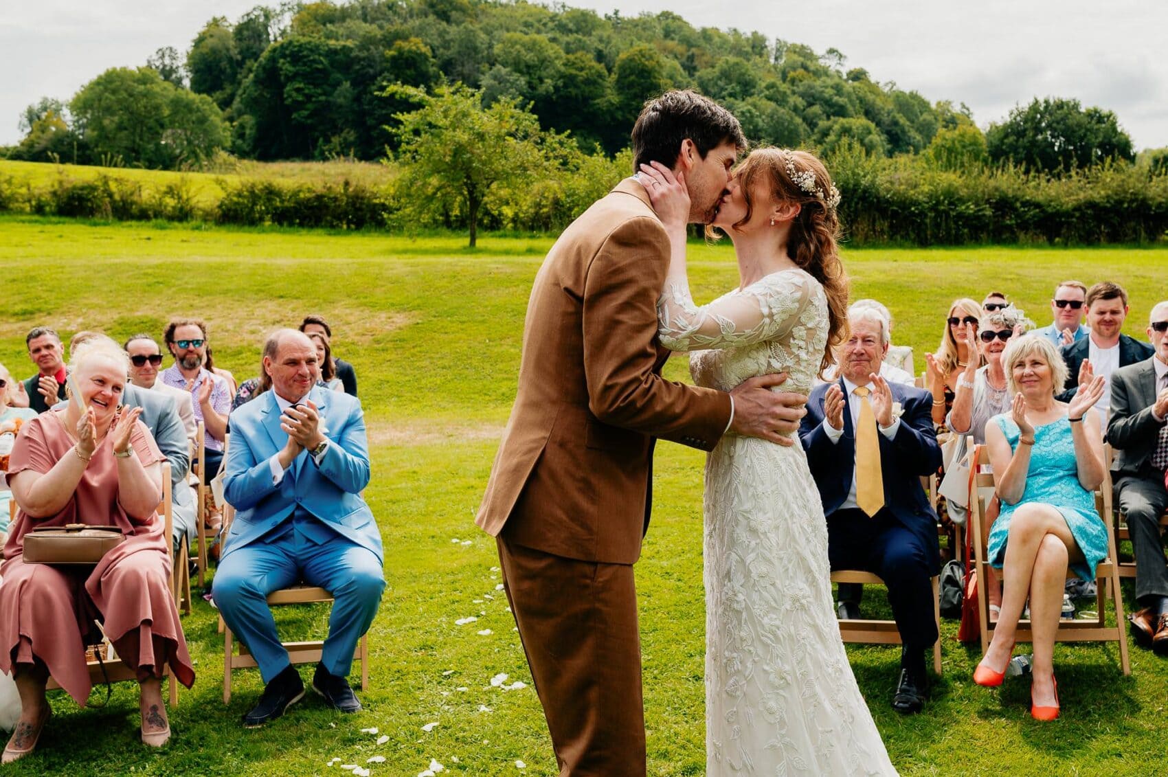 parents celebrate the first kiss of the new marriage at Owlpen Manor weddding