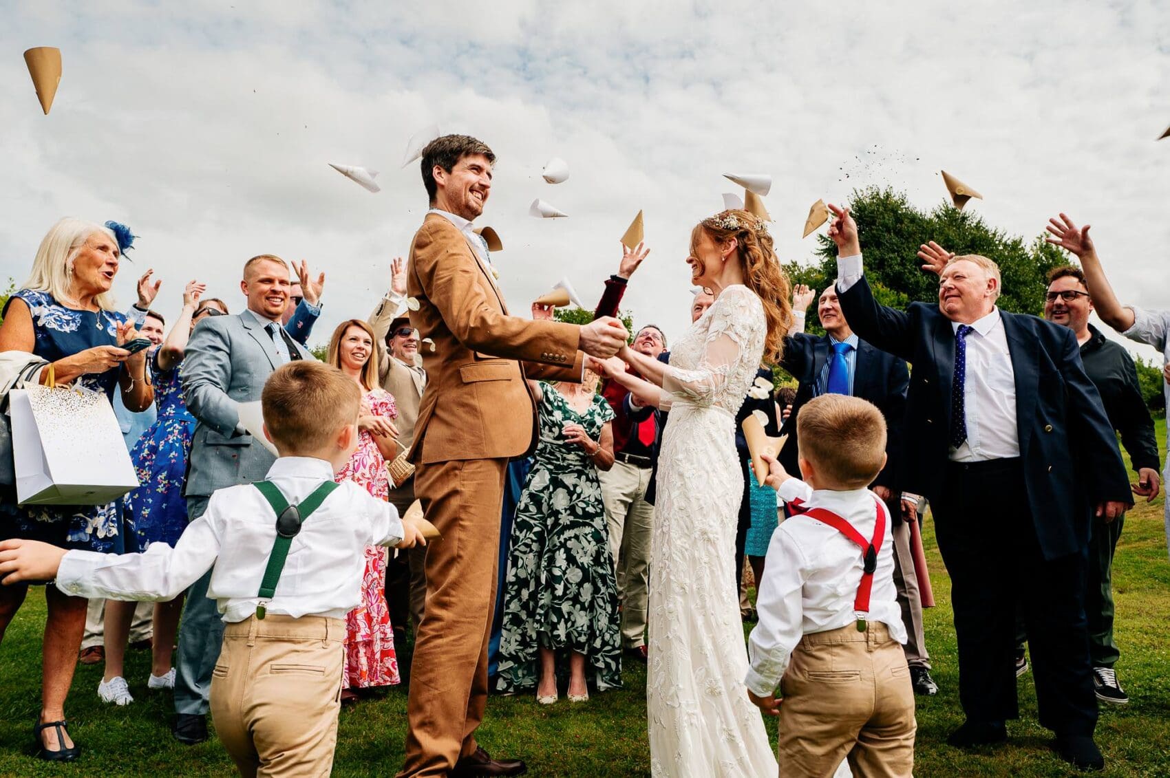 Confetti cones being thrown at the couple during Owlpen Manor weddding