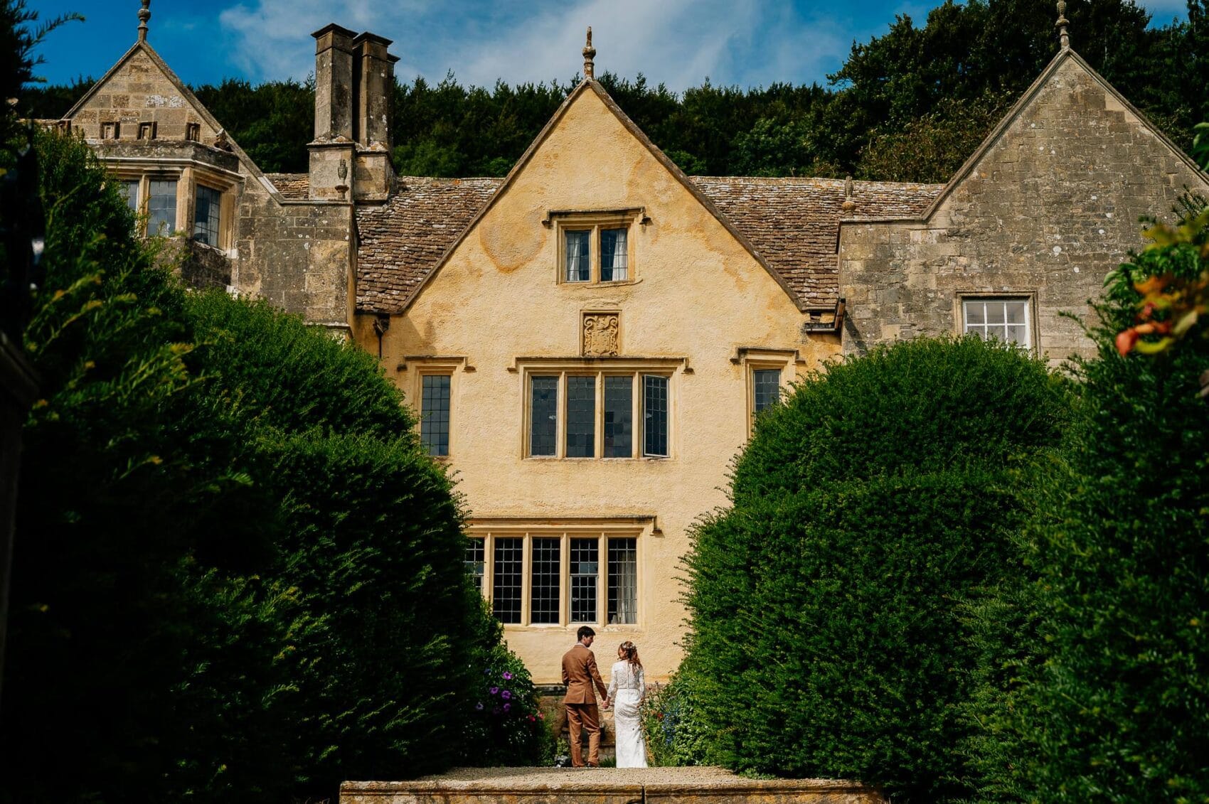 Bride and groom have a quiet moment together at Owlpen Manor weddding in the kitchen garden