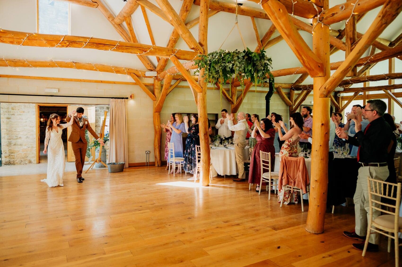 Bride and groom enter the wedding breakfast at Owlpen Manor weddding