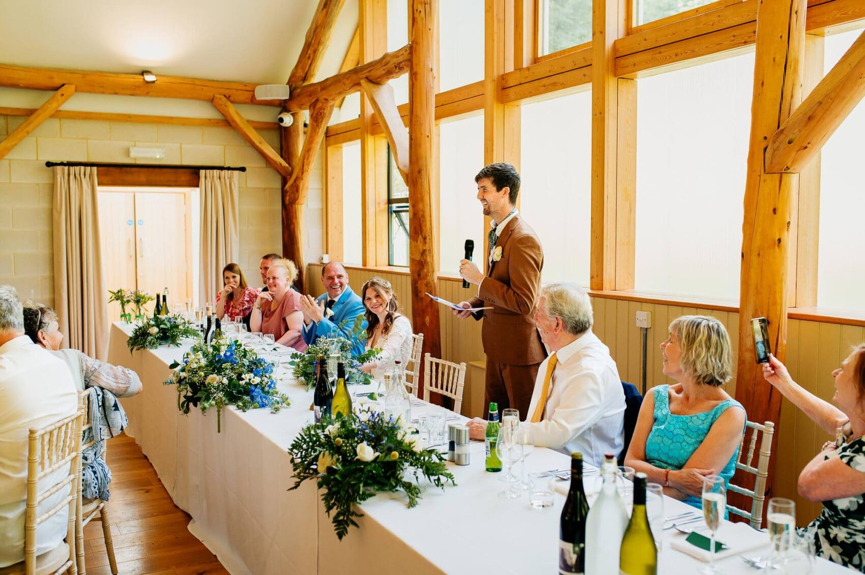 Groom makes people laugh at his wedding at Owlpen Manor weddding