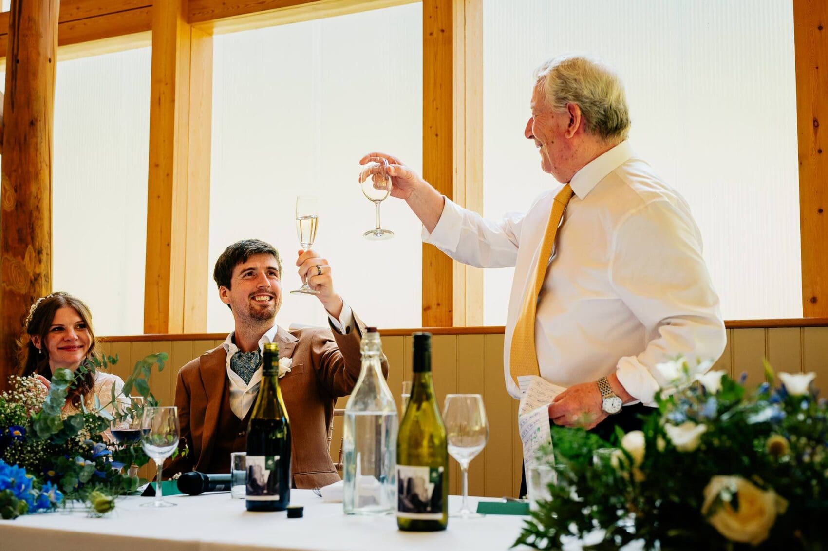 Father of the groom and his son toast to the bride