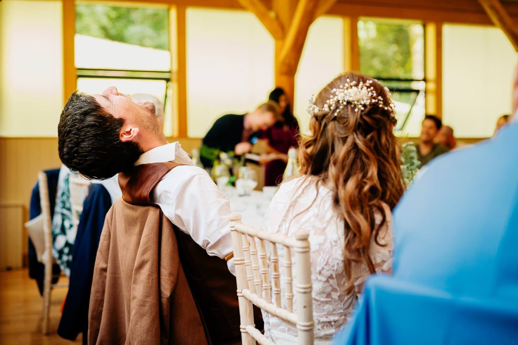 Groom laughing at speeches