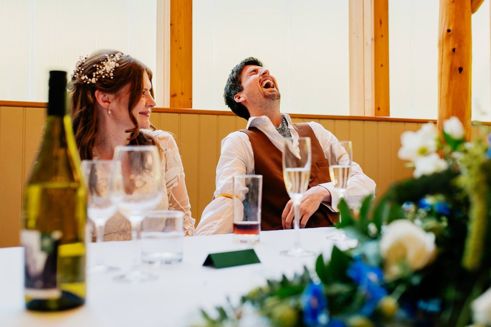 Groom laughing hard at the speeches during Owlpen Manor weddding