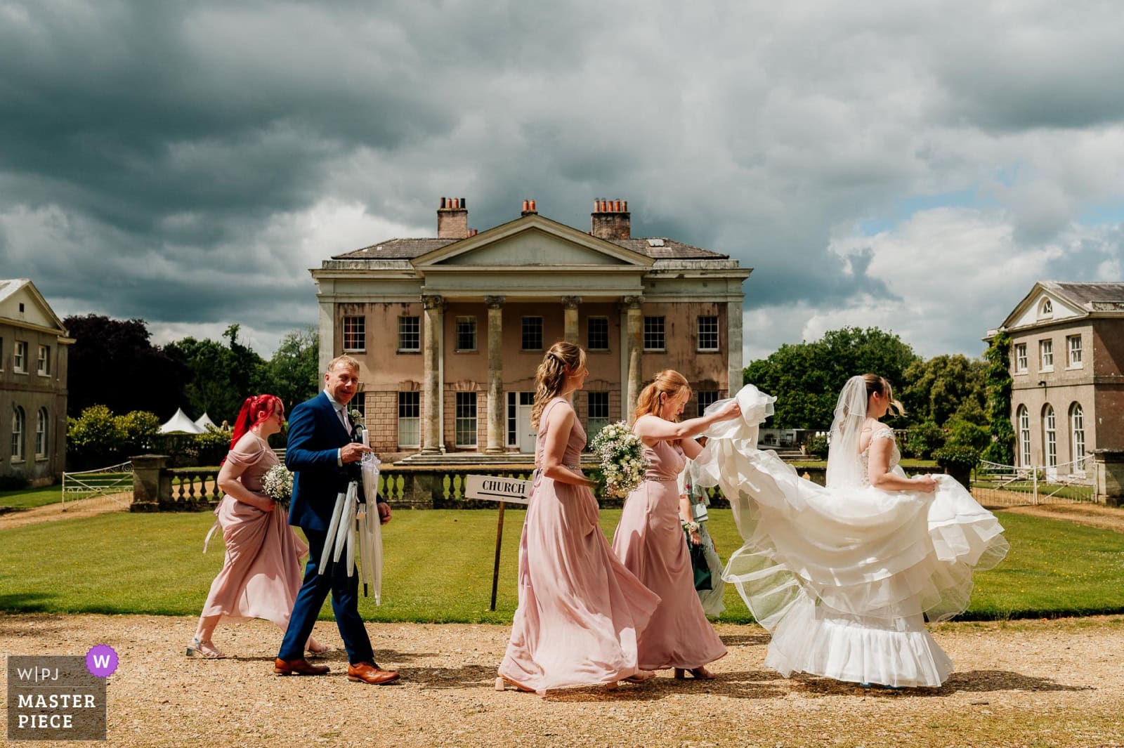 WPJA award wiinning photo of bride walking past Hale Park House