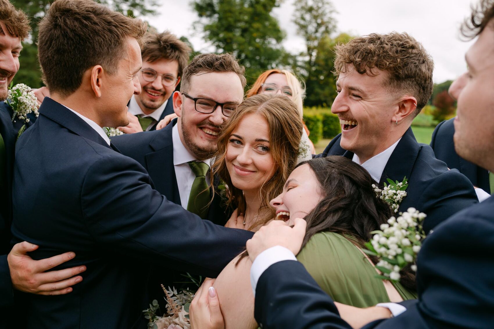The whole Bridal Party hug before St Giles House