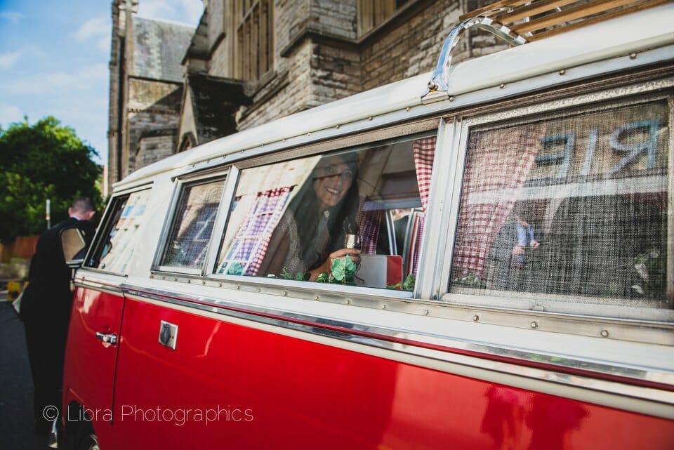 Bride looks out from Camper van