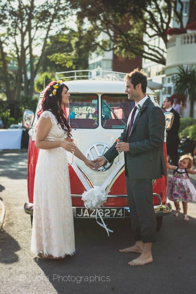 Bride and groom stand by their campervan - Miramar Hotel
