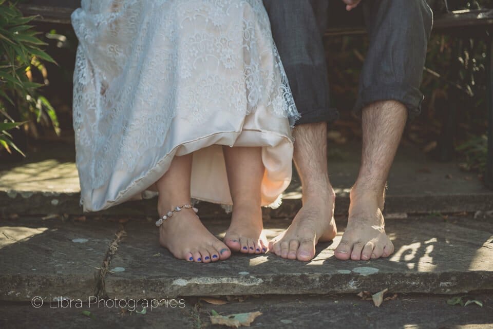Bride and groom's bare beach feet
