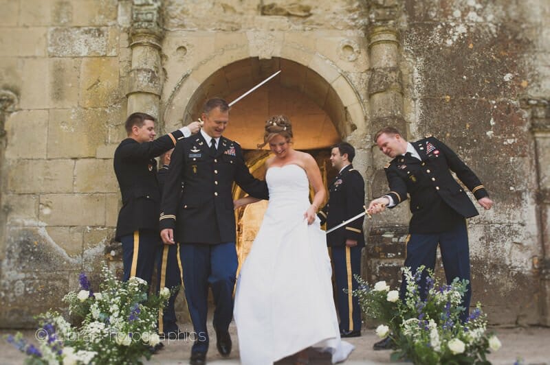 Commanding officer taps bride with sword